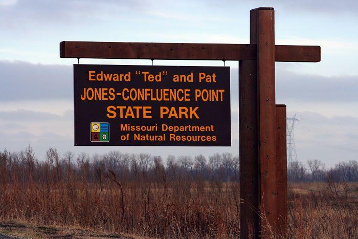 Brown cantilever sign that says Edward “Ted” and Pat Jones-Confluence Point State Park with “Missouri Department of Natural Resources” and the logo.