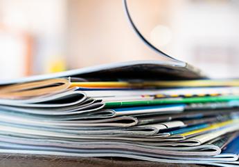 A stack of brochures and magazines