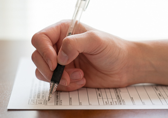 An individual filling out a department form
