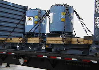Canisters of radioactive material being shipped on a flatbed trailer