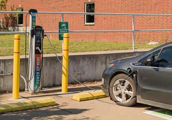 An electric car is plugged into a charging station.