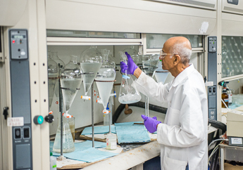 A MoDNR Environmental Services Program team member working in the MoDNR laboratory testing a sample