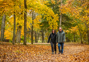 A couple hiking on a trail at the Dillard Mill State Historic Site in Davisville, Missouri