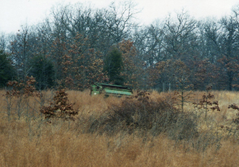 Abandoned machinery used to spread the sludge at the Camdenton Sludge Disposal Area during the application activities from December 1989 through March 1990.