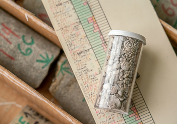 A hand-drawn well log laying on top of a core sample