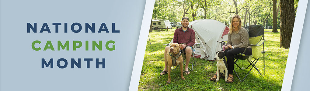 A couple and their two dogs sitting in front of a tent at a Missouri state park camping site