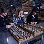 Three geologists examine rock core samples at McCracken Core Library and Research Center