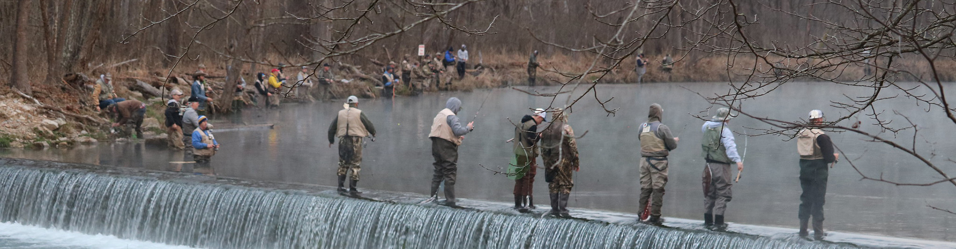 Anglers line up in the river during Trout opening day at Montauk State Park