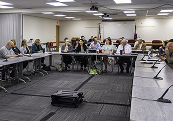 Energy Stakeholder Forum meeting attendees sit at tables in a conference room