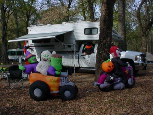 Campsite decorated to participate in Halloween decorating contest. Inflatable Frankenstein, mummy and witch riding an UTV.