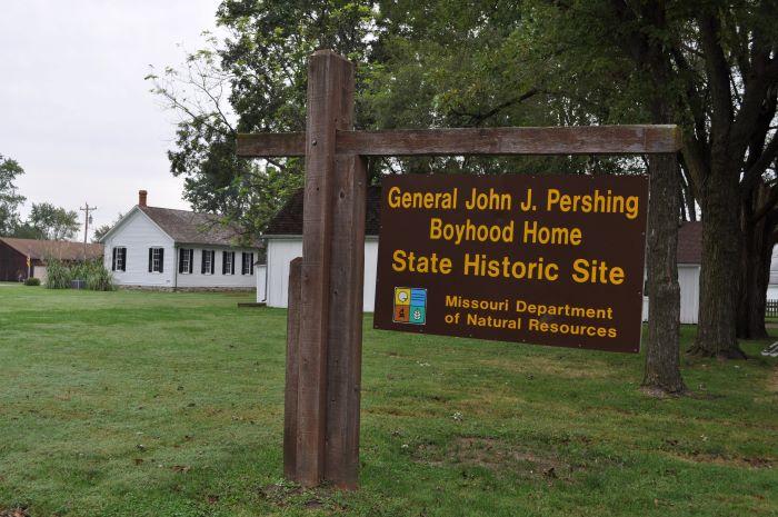 Brown cantilever sign in front of Gen. John J. Pershing’s boyhood home