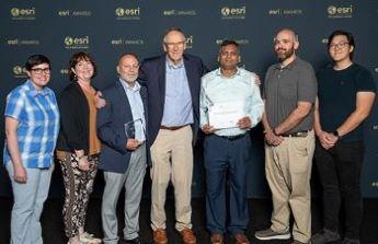 Six team members from the Department of Natural Resources, OA and Esri holding Special Achievement in GIS Award