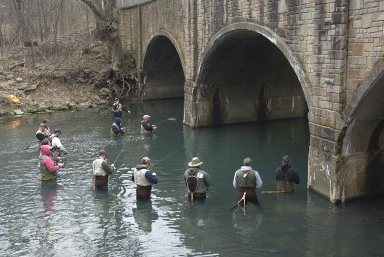 Anglers fishing beneath the arched bridge at Bennett Spring State Park
