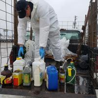 Hazardous waste contractor unloading unwanted pesticide from a participant’s vehicle at the Jefferson City pesticide collection event