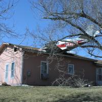 Environmental emergency response responded to contain a fuel release after a plane crashes on a house.