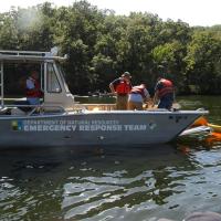 Environmental emergency response train on deployment of absorbent boom at Lake of the Ozarks.
