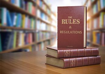 Rules and regulations books sitting on a desk in a library