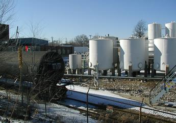 A railcar sitting in front of the above ground tank farm at Nexeo Solutions
