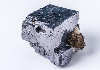 Gray, cubic cleavage specimen of metallic galena with a crystal