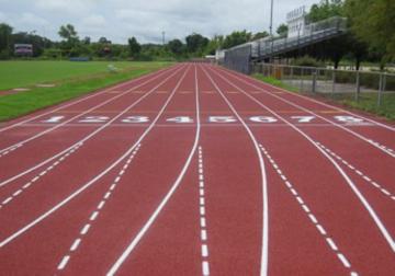 High school running track made bouncy by ground tire rubber.