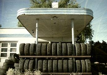 Racks of scrap tires collected at a gas station