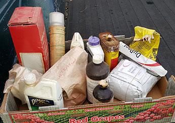 A variety of pesticides in a cardboard box