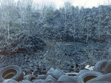 Scrap tires discarded on a hillside at the DWM3 tire site