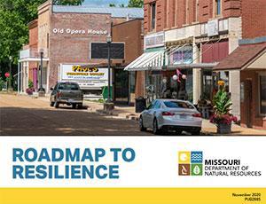 Cover art for the Roadmap to Resilience publication, featuring a street scene with cars parked in front of buildings.