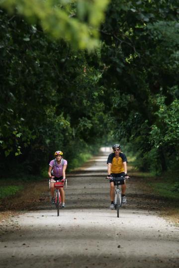 Two people riding bikes on Katy Trail State Park in Weldon Spring