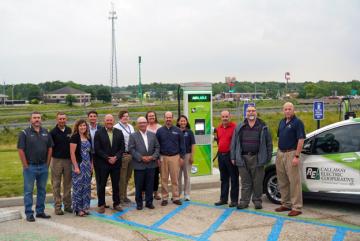 MoDNR staff and grant awardees stand next to an electric vehicle charging station completed in May 2021.