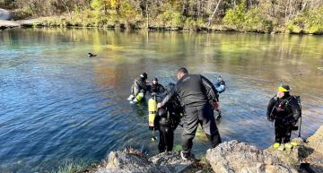 Divers enter Bennett Spring during 2021 Stream Team Clean-up