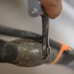 A silver key scratching the wipe joint of a lead pipe