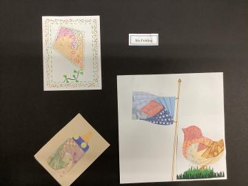 Examples of colorful items including kite, flag, bird and baby bottle  created using iris folding method