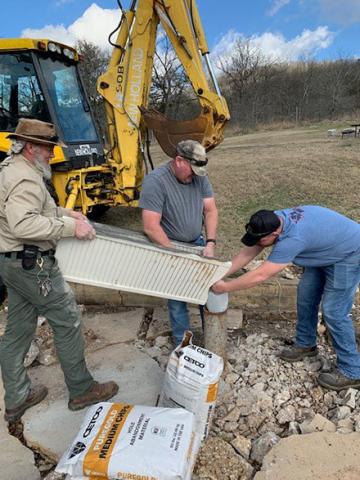 Three DNR staff using their equipment to plug an abandoned well at Johnson's Shut-Ins State Park