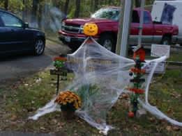 Campsite decorated with a ghost made of fake spider web and jack-o'-lantern