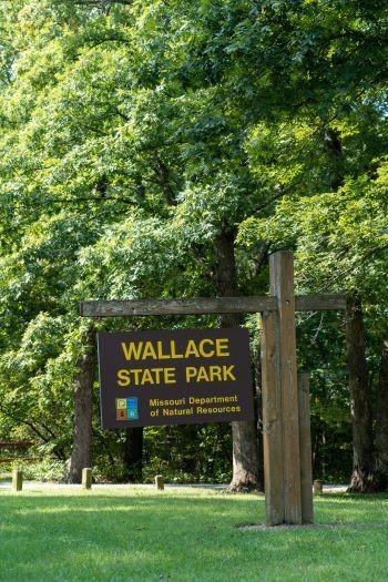 Brown cantilever sign saying “Wallace State Park, Missouri Department of Natural Resources.”