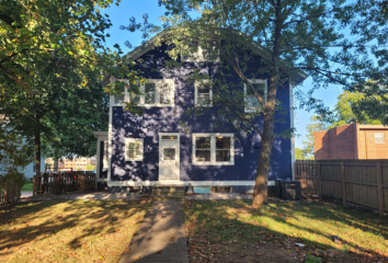 After photo shows a rehabbed house that is a blue, three-story house that has been updated and repaired.