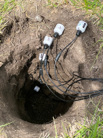 A picture showing wires connecting to monitoring equipment within the pit of a MoDNR groundwater-level observation well in Sedalia. 