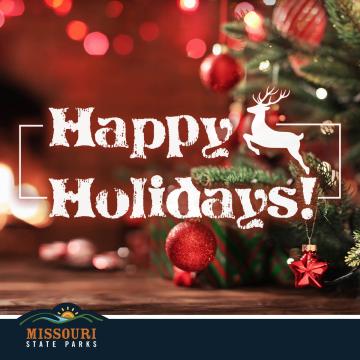 Happy Holidays card with a white deer over a background of a tree decorated with red ornaments.