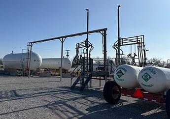 A facility used for storing anhydrous ammonia in pressure vessels and transferring the liquid fertilizer by swing booms into mobile nurse tanks for field application