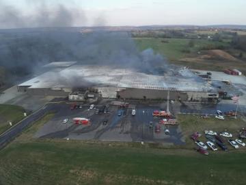 Smoke pours fro the roof of Critical Mineral Recovery's facility
