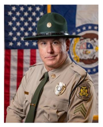 Sergent David Miller in uniform smiling.